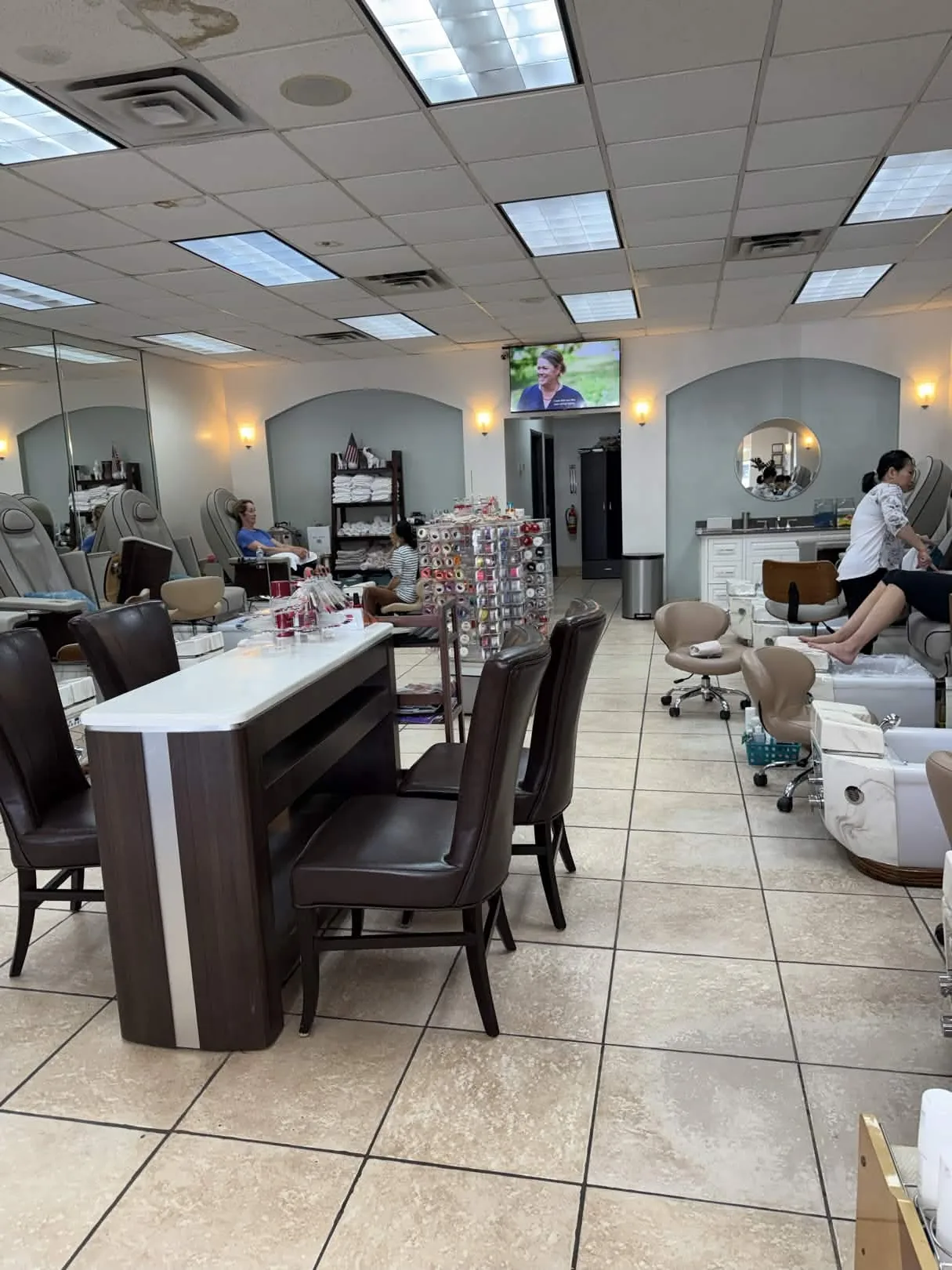 Pedicure chairs and salon floor inside Nails Labelle at 5607 W Lovers Ln, Dallas, TX