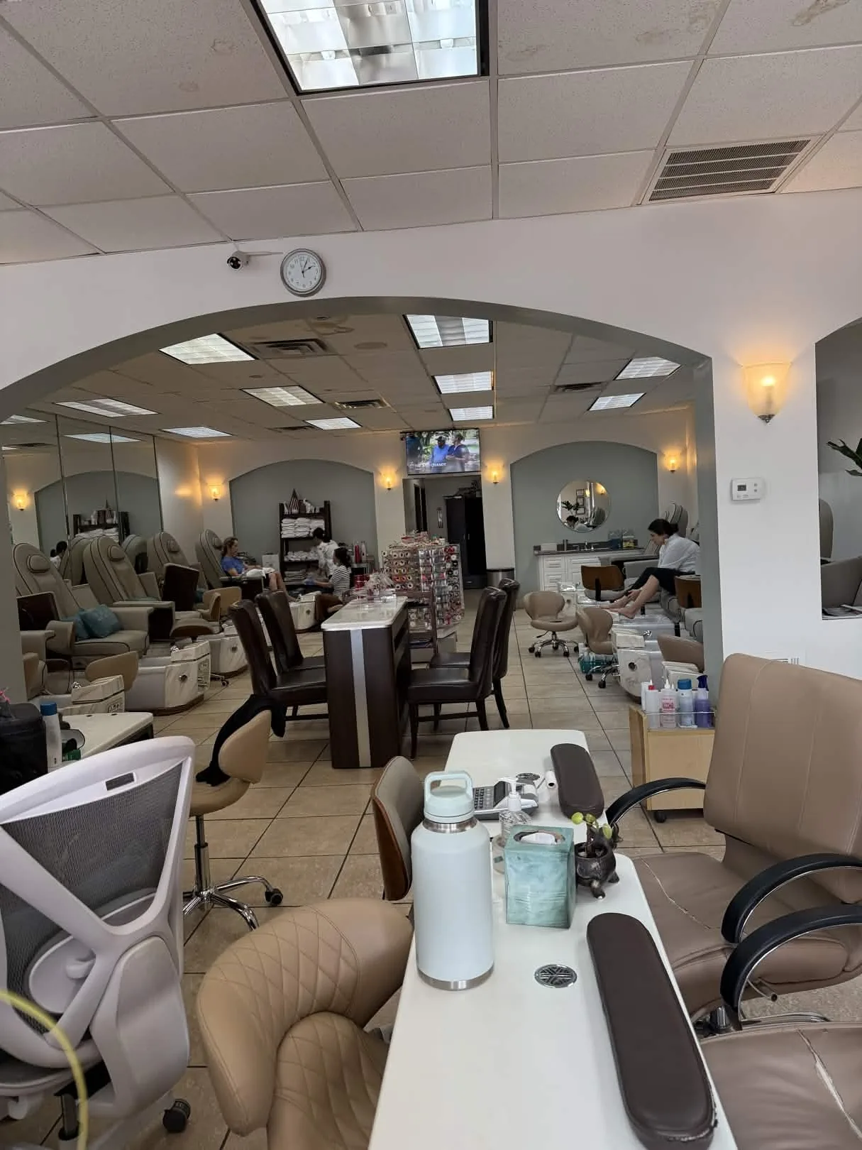 Interior of Nails Labelle salon on Lovers Lane in Dallas, TX, showing manicure stations and archways